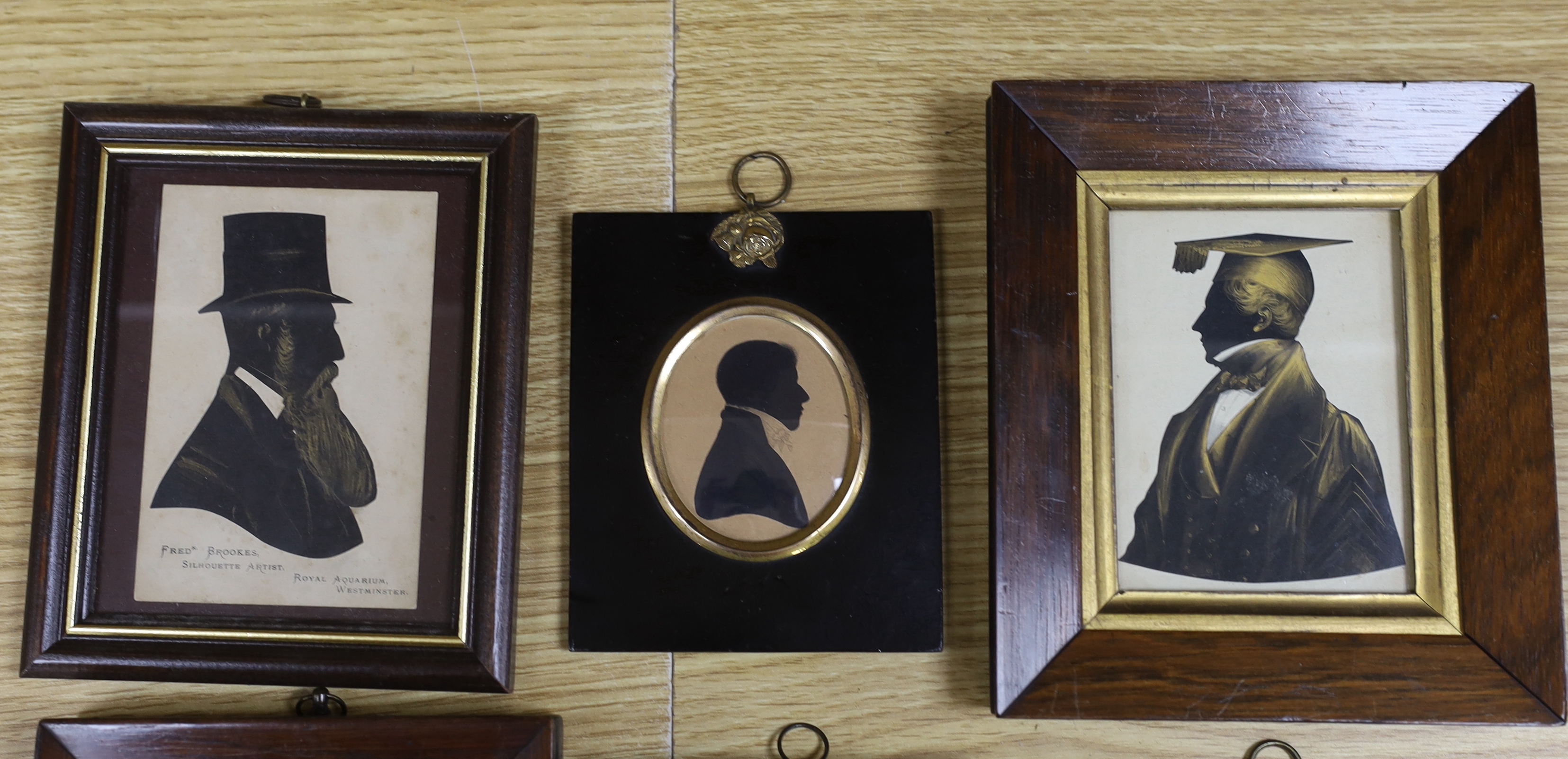 Six assorted 19th century silhouettes including H.J. Walter, cut and bronzed profile of a boy, 1850, 9 x 6cm; Fred Brookes, profile of a bearded gentleman and a bronzed study of a tutor, 10 x 7.5cm